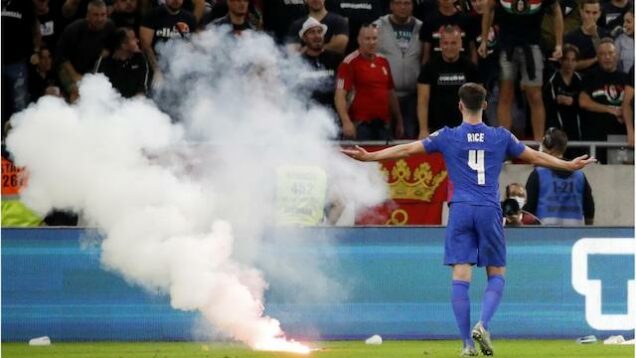 Objects including a flare thrown on the pitchat Budapest in Hungary v England