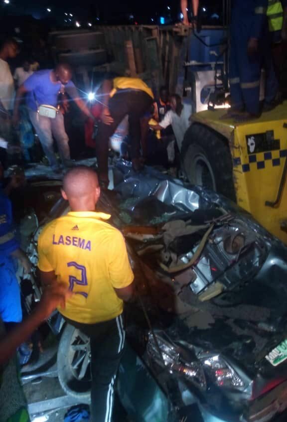 Four persons cheat death in Lagos as fallen-container crushes vehicle