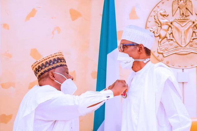 President Buhari being decorated with emblem during the launch of the 2022 Armed Forces Remembrance Day emblem appeal launch in Aso rock presidential villa, Abuja on Monday