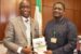 Special Adviser to the President on Media and Publicity, Femi Adesina receiving a publication of CIPM from its President Olusegun Mojeed.