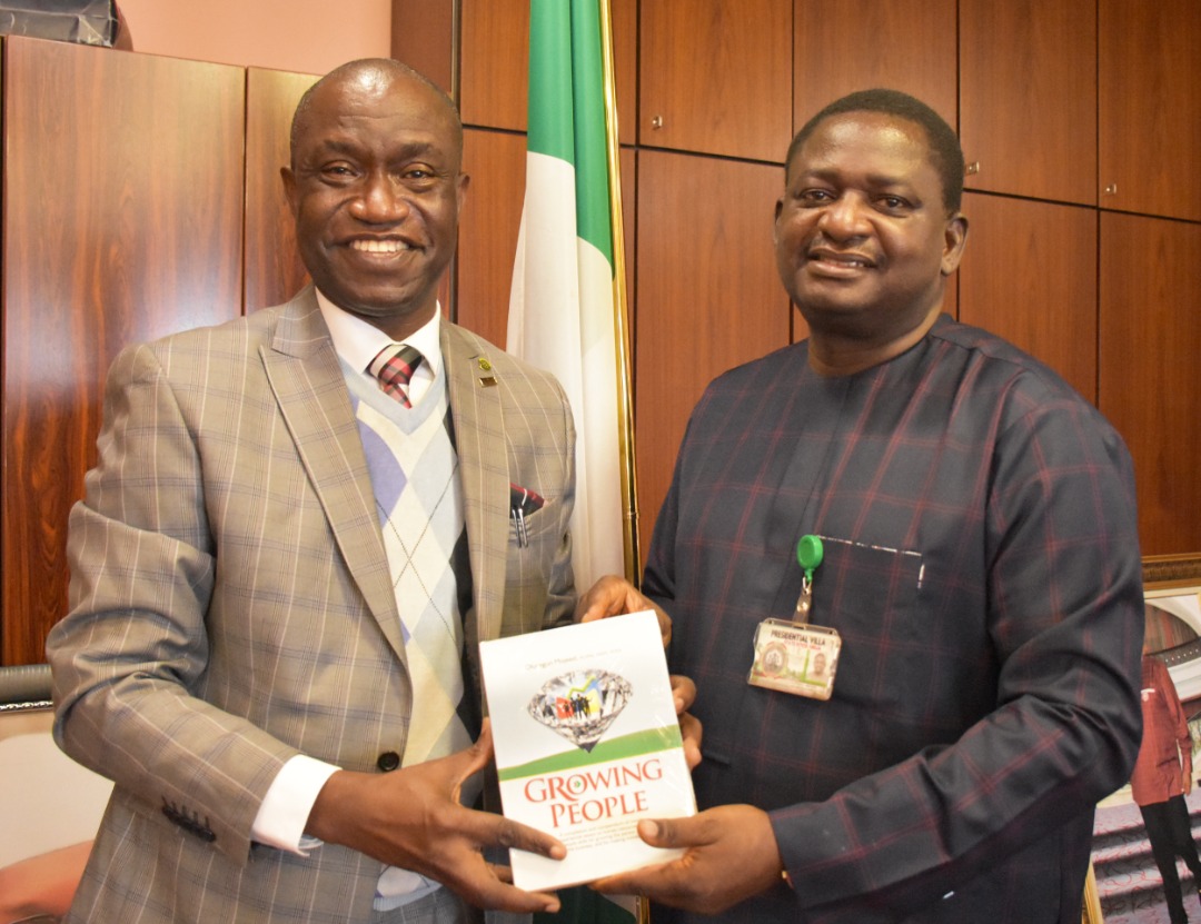 Special Adviser to the President on Media and Publicity, Femi Adesina receiving a publication of CIPM from its President Olusegun Mojeed.