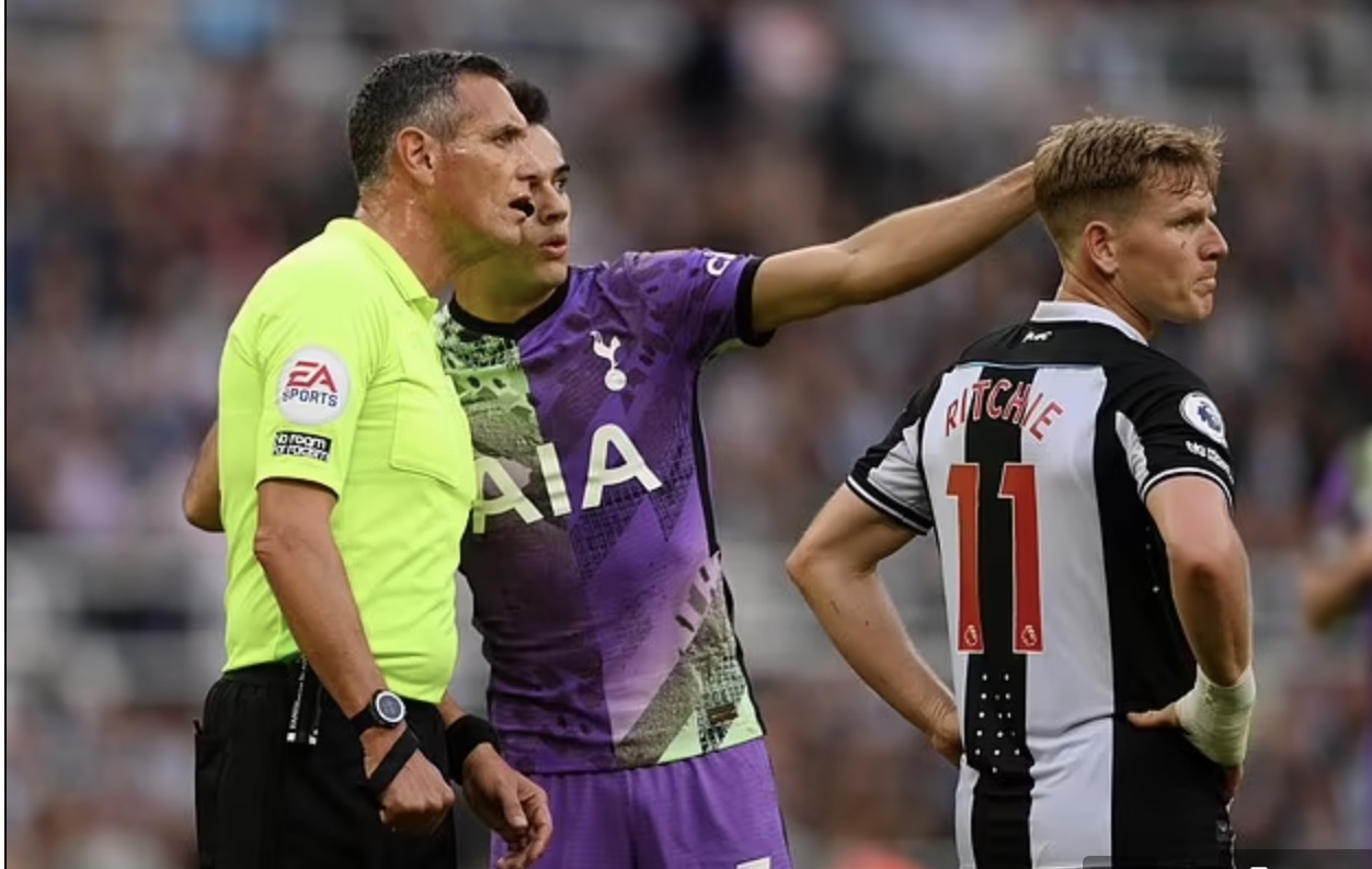 Referee Marriner being told about the unfolding medical incident