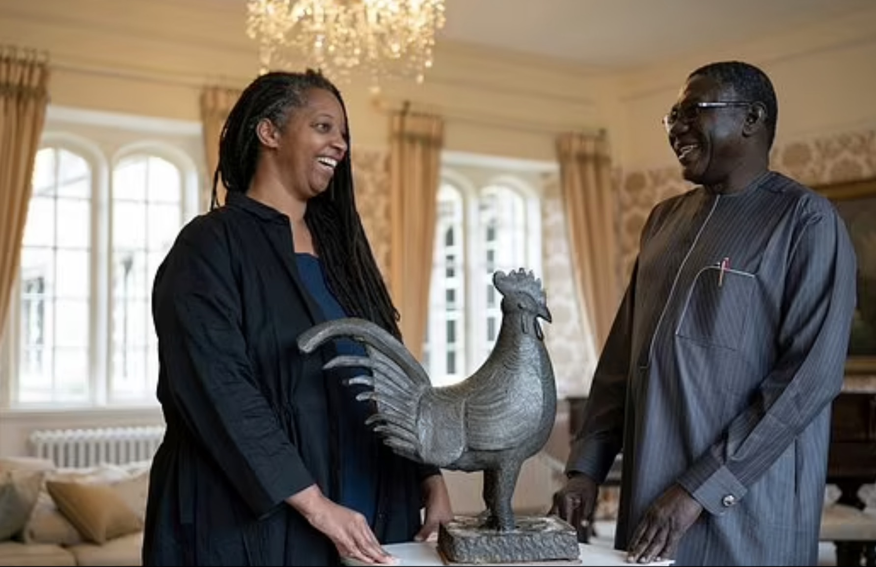 Master of Jesus College Sonita Alleyne, left and Director General of Nigeria's National Commission for Museums and Monuments Professor Abba Isa Tijani pose with Benin cockerel statue