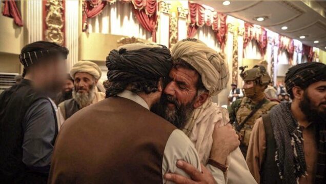 Sirajuddin Haqqani, face blurred, left meets one of the families of suicide bombers