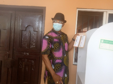 Mr Okeke displaying his ballot paper to show he voted APC 