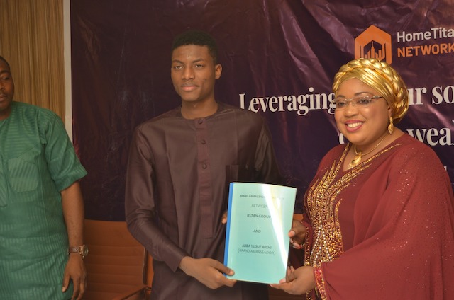 Becky Olubukola hands over the ambassadorial contract paper to Abba Yusuf Bichi