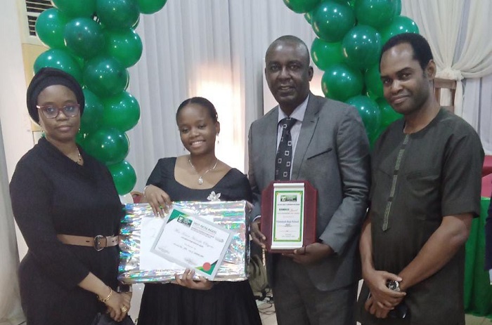 L-R: Mrs Kasim, Mother; Kasim Haneefa Olayemi, Winner Sidmach Prize, Mr Kasim, Father and Mr Jide Onigbogi, Principal, Chrisland High School VGC during the presentation of awards in Lagos.