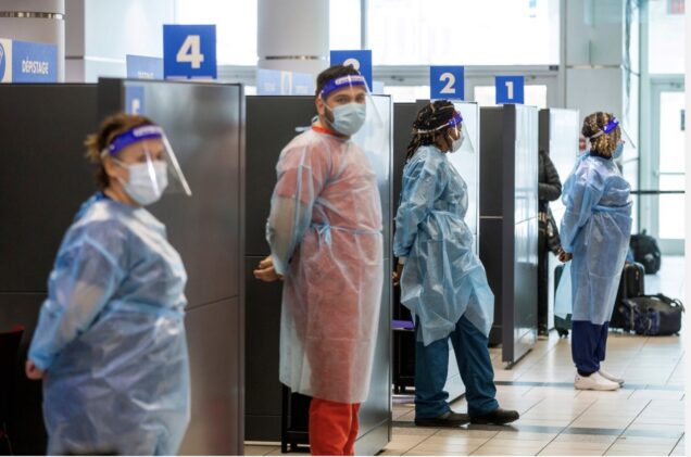 Health workers at an airport in Canada waiting to test travellers