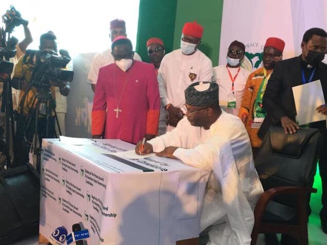INEC chairman Mahmood signs the peace accord