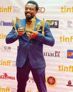 Austin Odigie displaying the five awards won by Empathy the Toronto International Nollywood Film Festival (tinff)