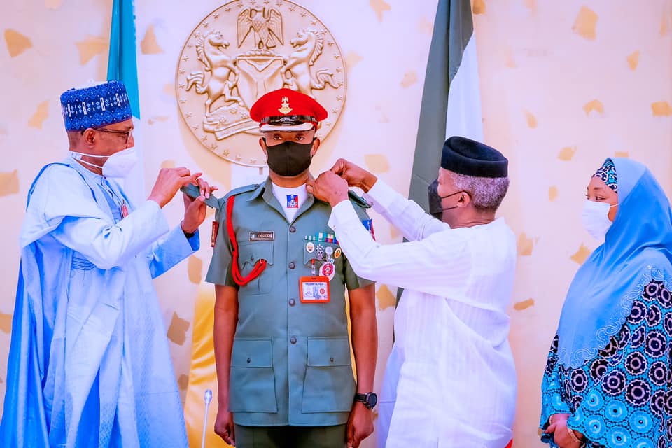 Buhari and Osinbajo decorating Col. YM Dodo