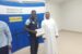 Abraham Airaodion receiving a certificate of appreciation from Sharjah Taxi