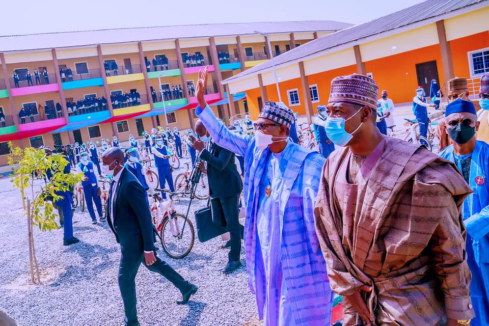 Buhari waving to supporters at the unveiling of Tijjani Bolori Memorial Secondary School