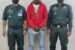 Chibueze (middle) arrested by the police