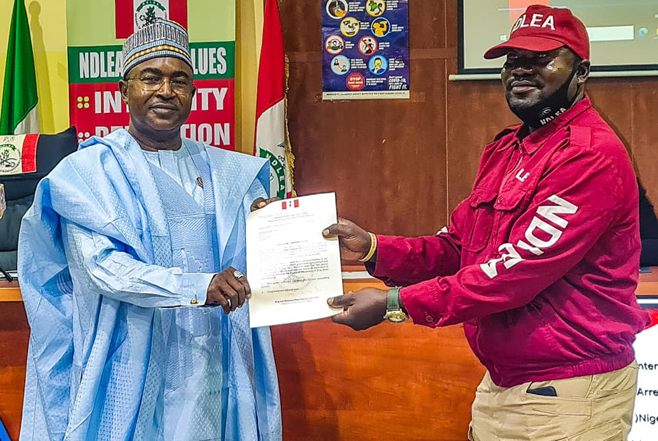 NDLEA Chairman, Buba Marwa presenting award to one of the operatives of the agency. He said the agency arrested 11,340 suspected drug traffickers and secured 1,111 convictions in 11 months.