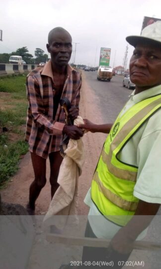 An official of Ogun State Waste Management Authority, OGWAMA (right) with a man arrested for engaging in open defecation