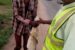 An official of Ogun State Waste Management Authority, OGWAMA (right) with a man arrested for engaging in open defecation