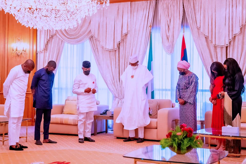 Buhari and members of VP Osinbajo family praying with the President during the visit 