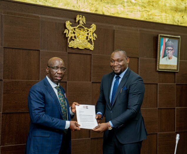 Managing Director/Chief Executive Officer of Abdul Samad Rabiu Africa Initiative, Dr. Ubon Udoh presenting letter of the award to  Governor Obaseki