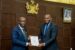 Managing Director/Chief Executive Officer of Abdul Samad Rabiu Africa Initiative, Dr. Ubon Udoh presenting letter of the award to Governor Obaseki