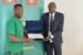 Captain Ahmed Musa (left) receives the certificate of welcome from CAF General Coordinator Titus Kunamuene.