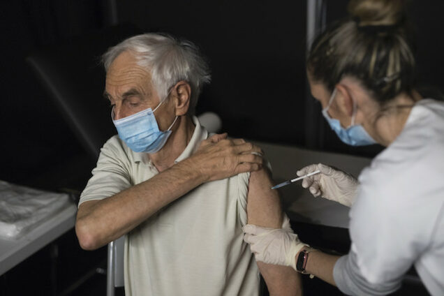 A French man takes the COVID-19 vaccine jab