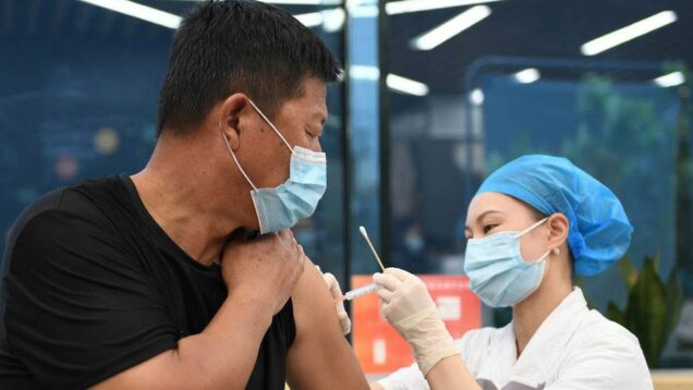 A chinese man receives COVID-19 vaccine jab