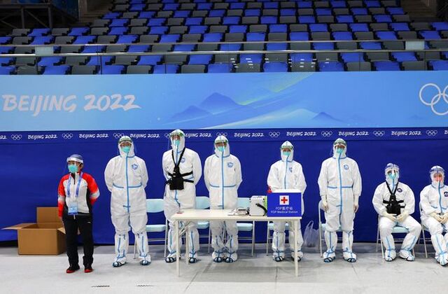 Paramedics wearing protective suits to protect from coronavirus disease (COVID-19) watch China's ice hockey team during a training session ahead of the Beijing 2022 Winter Olympics at the National Indoor Stadium in Beijing, China January 29, 2022. REUTERS/Fabrizio Bensch
