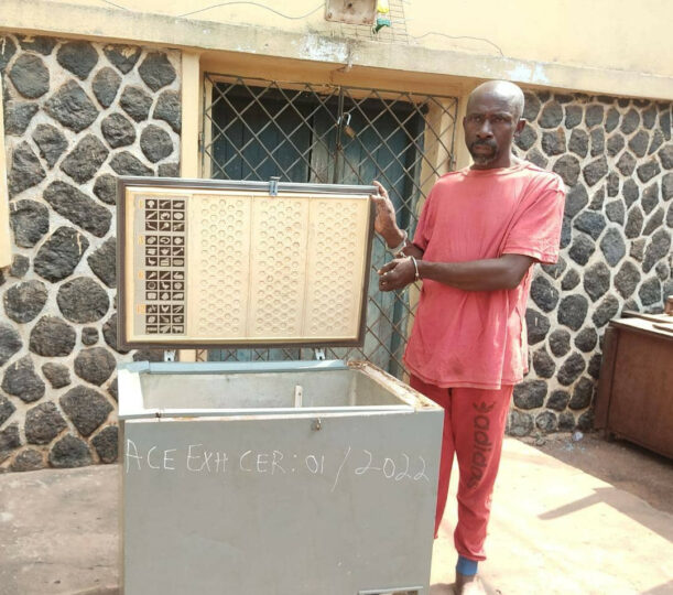 Ifeanyi Amadikwa and the freezer used to keep bodies of his three kids