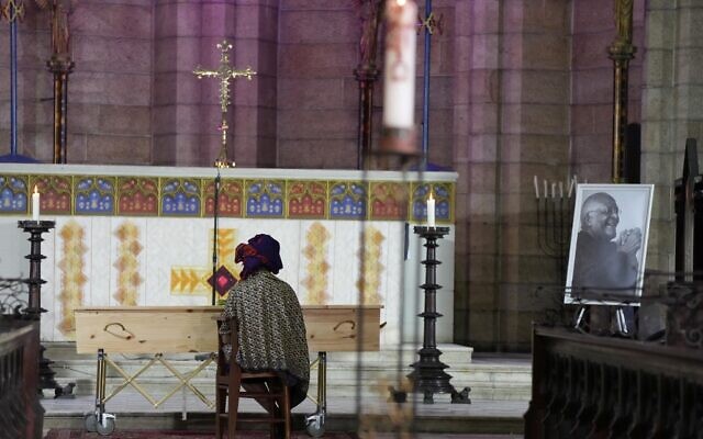 Mpho Tutu van Furth, daughter of Archbishop Desmond Tutu, sits quietly on her own next to his coffin ahead of the requiem mass