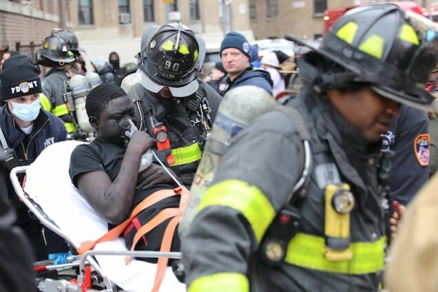 a victim of the Bronx fire being stretchered away