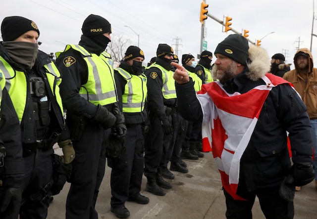 A protester taunts the police at Ambassador Bridge