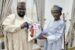 Aminu Suleiman DG of Tinubu Support Group presents a branded gift to Adamu
