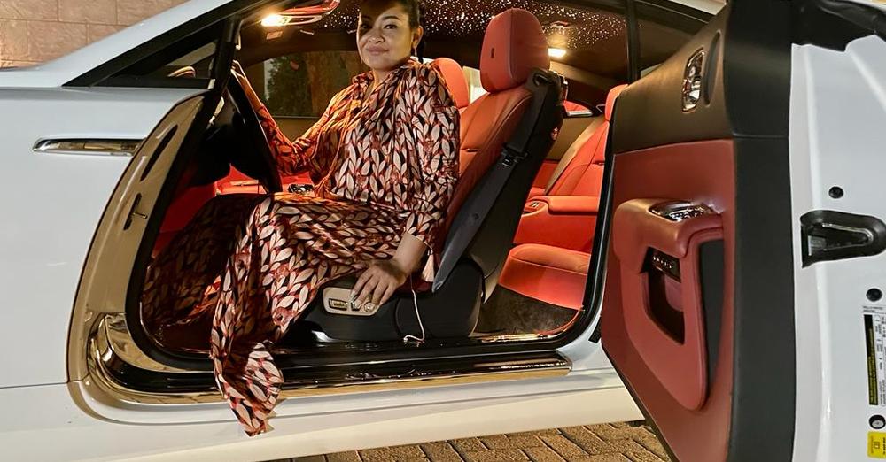Natasha Akpoti poses with a Rolls Royce gift from Uduaghan