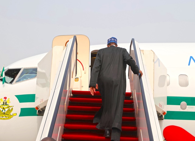 The president ascending the plane in readiness for departure