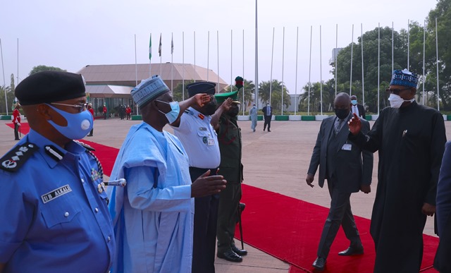 The president exchanging pleasantries with aides before departure