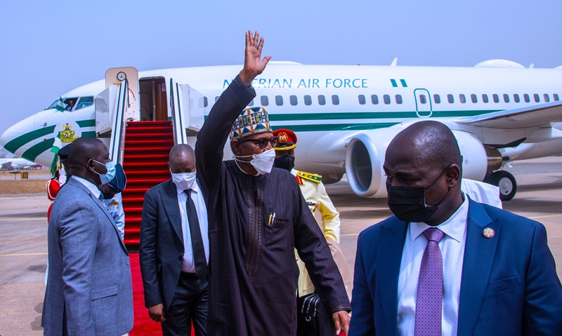 The president waving well wishers who came to welcome him at the airport
