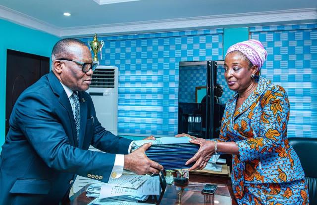 Mrs. Obaseki presenting copies of the Violence Against Persons Prohibition (VAPP) Law to Justice Acha