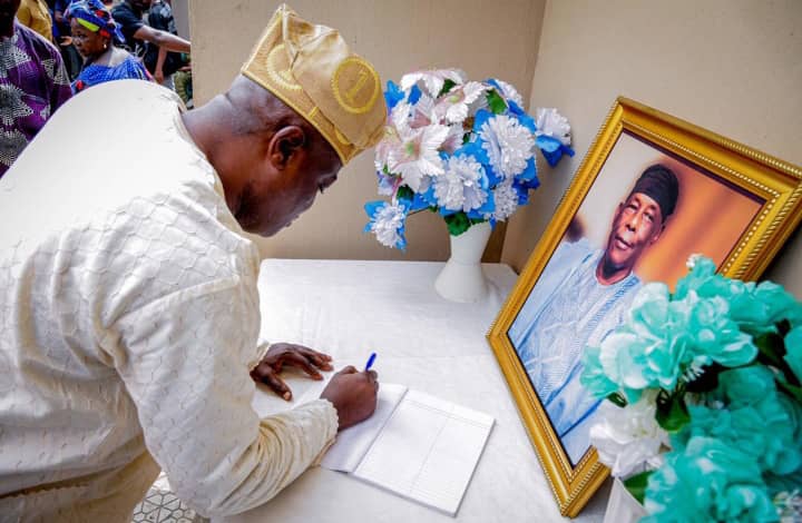 The Speaker, Lagos State House of Assembly, Mr Mudashiru Obasa, signing a condolence register at the residence of the late Prof. Tunde Samuel in Lagos on Thursday
