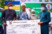 Lagos State Governor, Mr. Babajide Sanwo-Olu (left) and his deputy, Dr. Obafemi Hamzat (right) presenting compensation cheque to a representative of Olorunsogo Mosque (an affected property of the Bola Ahmed Tinubu Road construction) during a working visit to Ikorodu Division at Ikorodu Town Hall, Ikorodu on Thursday, 10th of March, 2022.