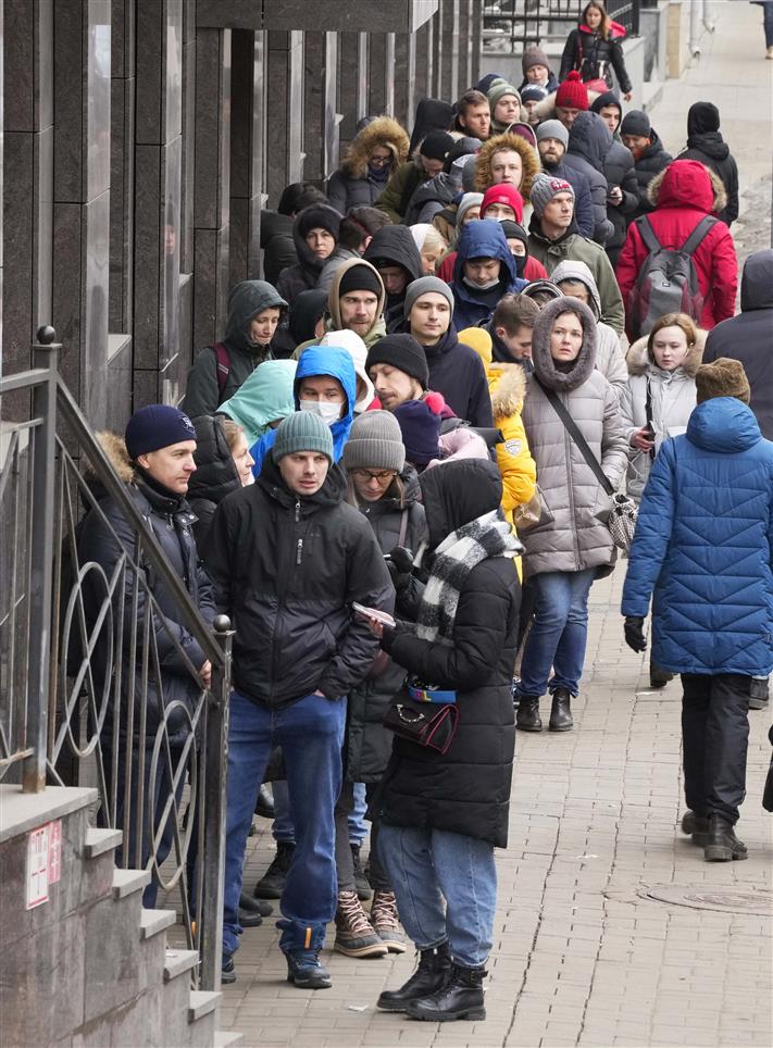 Russians queue for money at ATMs as sanctions hobble the economy