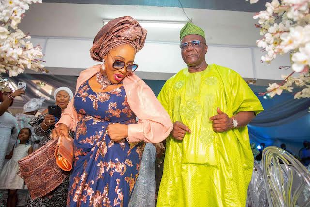 Toyin arrives at the hall with husband Bayo Onanuga