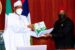 Buhari receives the report of the RMAFC from Engr Elisa Mbam