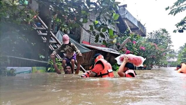 Emergency workers rescuing survivors in Philipines flood, landslide disaster