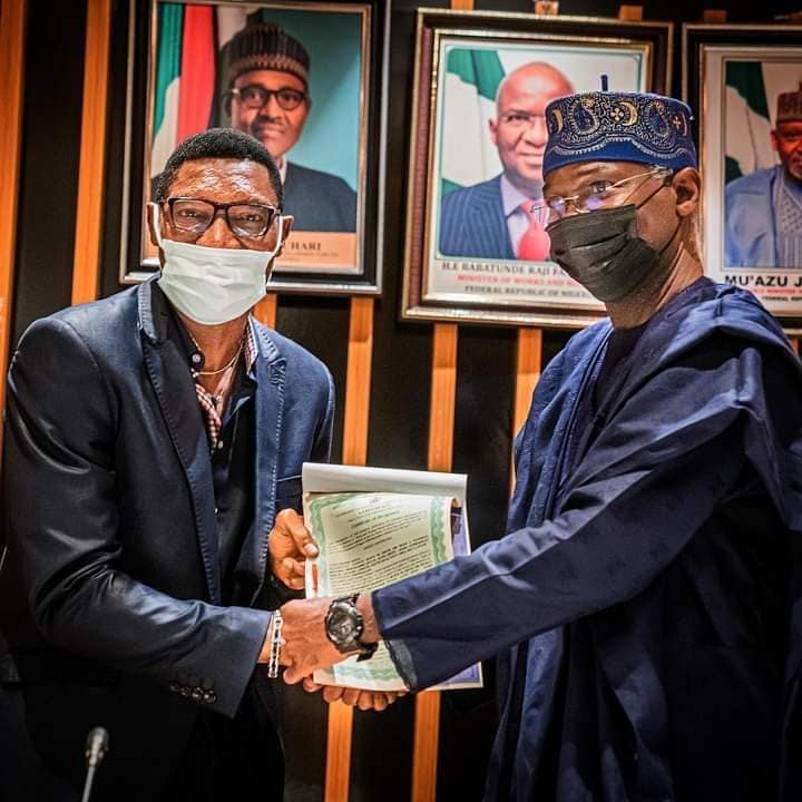 Fashola hands over the Cof O of the flat to Peter Rufai