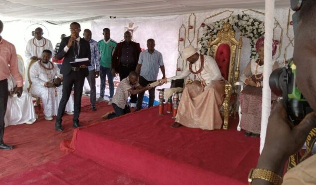 Olu of Warri presents a POS machine to one of the residents