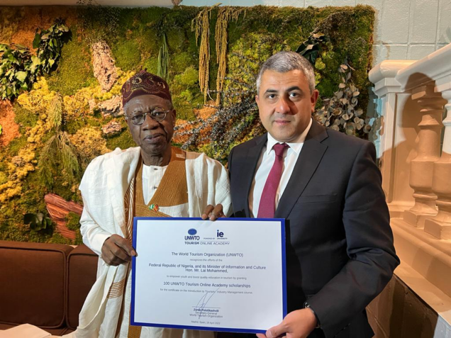 UN World Tourism Organization Secretary General Zurab Pololikashvili (right) presents offer of 100 Tourism Scholarships for Nigeria to the Minister of Information and Culture, Alhaji Lai Mohammed, in Madrid, Spain, on Tuesday night