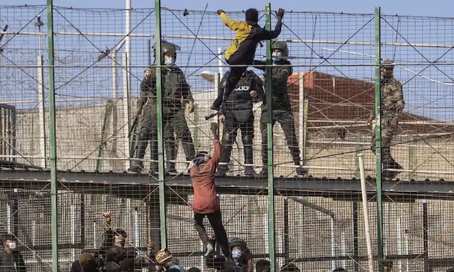 African migrants trying to cross from Morocco into Melilla Spain