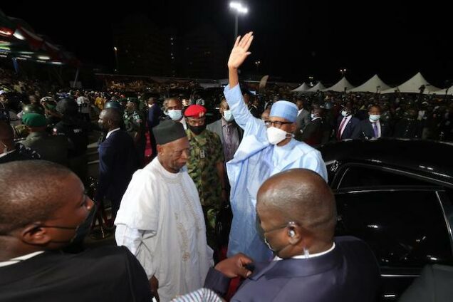 Buhari acknowledges cheers on arrival at the convention venue in Abuja