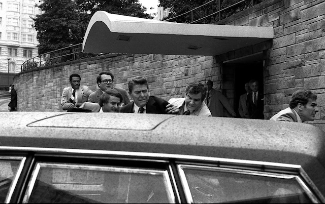 Reagan being escorted to his limo after shot by Hinckley